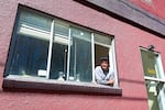 Anis Mojgani se asoma a la ventana de su estudio en Portland el 17 de abril de 2024.